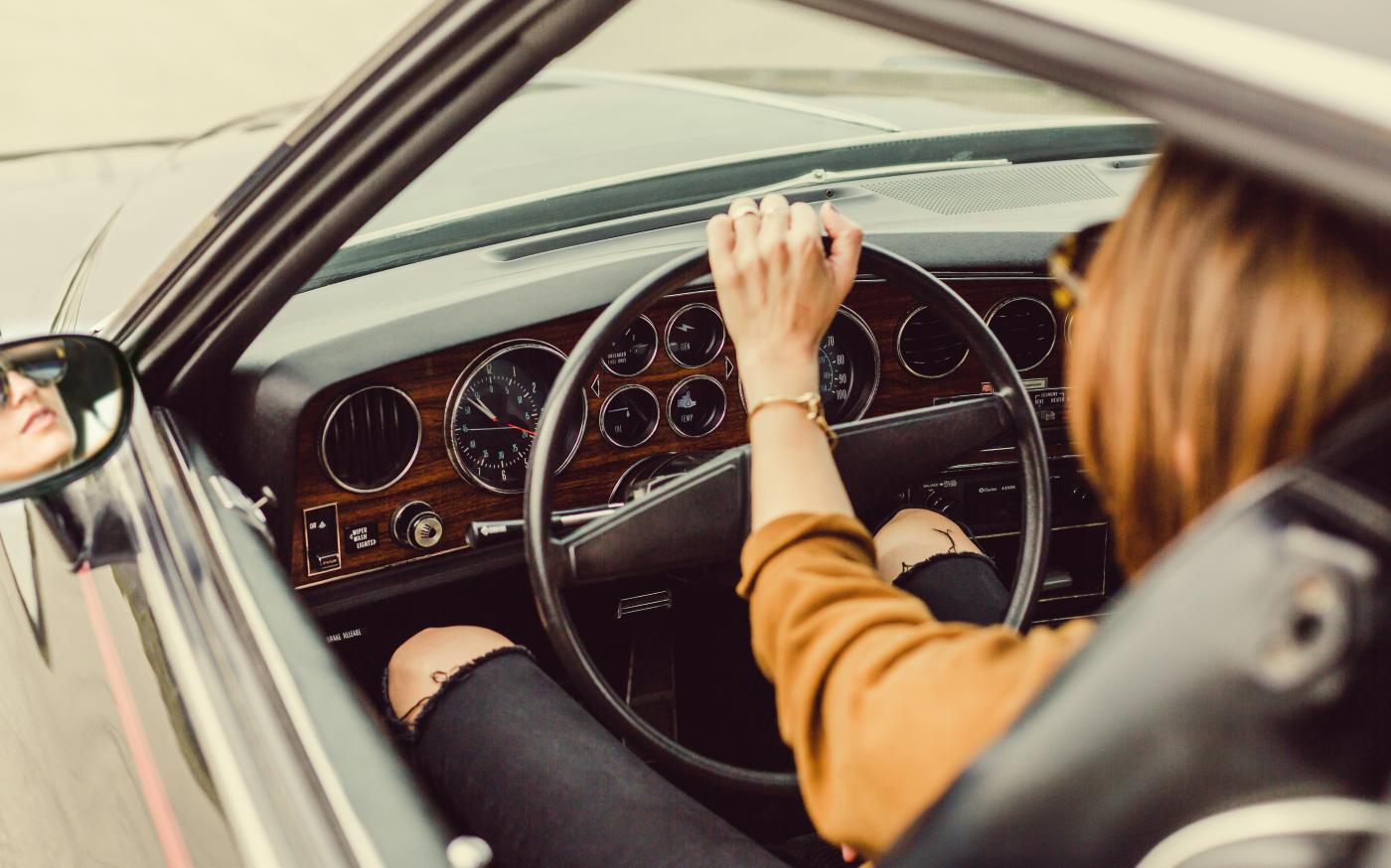 person sitting in the driver seat by Matthew Henry courtesy of Unsplash.