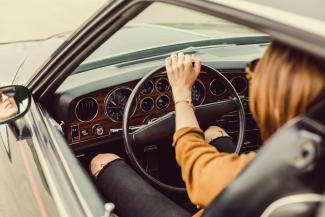 person sitting in the driver seat by Matthew Henry courtesy of Unsplash.