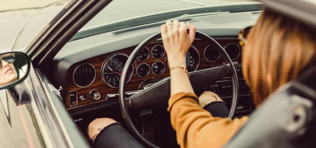 person sitting in the driver seat by Matthew Henry courtesy of Unsplash.